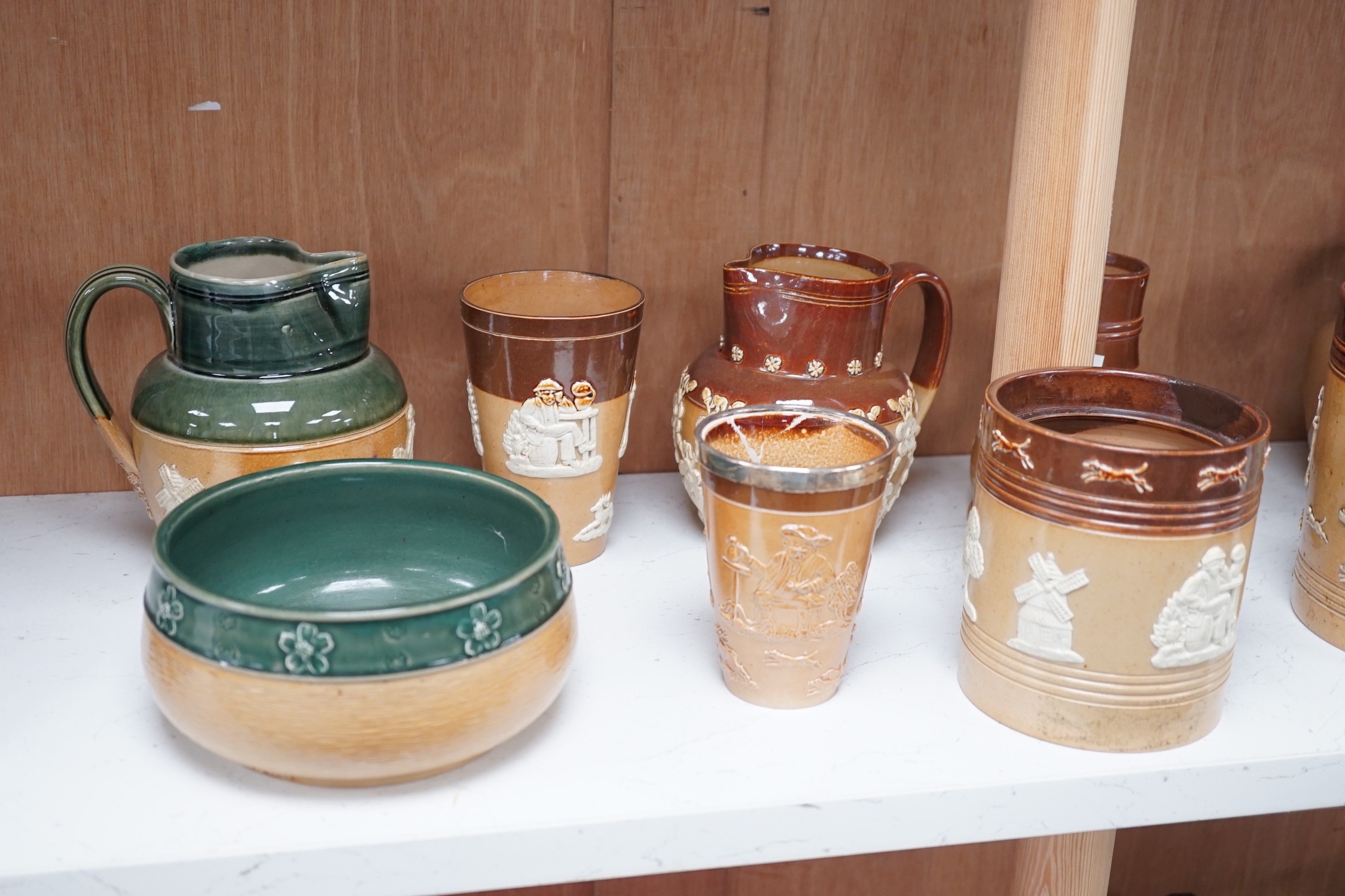 A group of Doulton stoneware jugs, storage jar, beakers, bowls etc